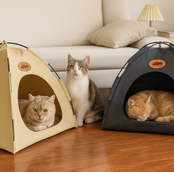 Three cats using beige and black portable cooling pet tents on a wooden floor in a cozy living room setting